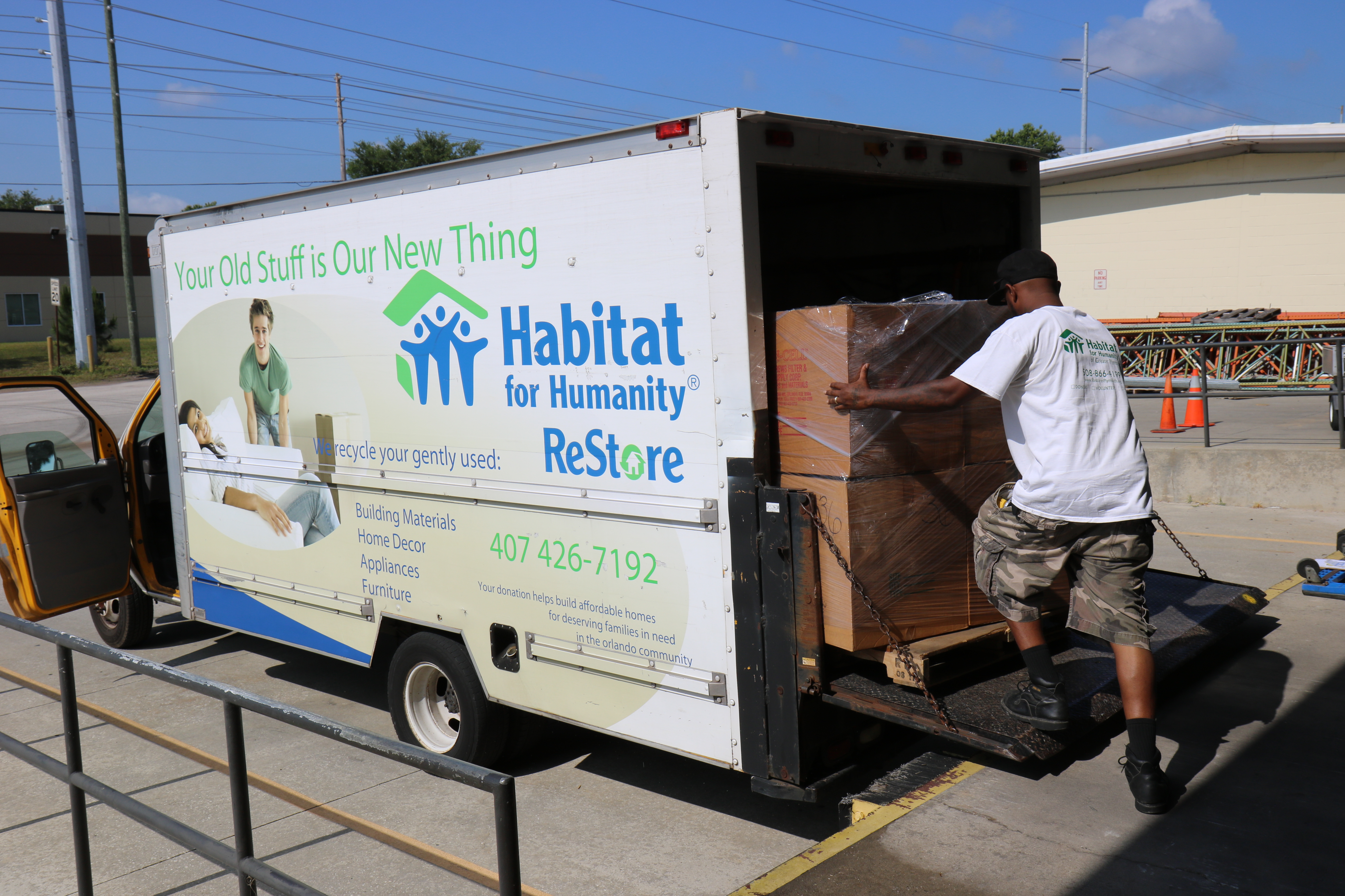 A man fills a Habitat for Humanity ReStore truck. 