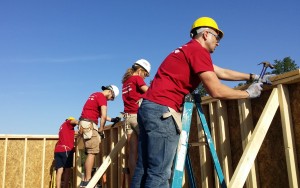 Four Habitat Orlando & Osceola volunteers hammer away at a home under construction