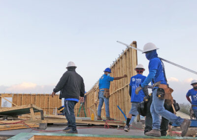 Workers at construction site with wooden walls